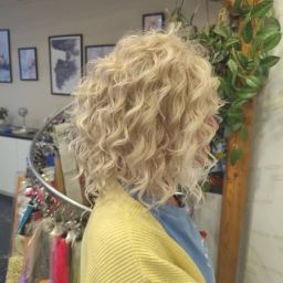 Jasnoblond afroloki do ramion w ujęciu z profilu